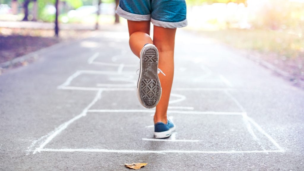 Kid playing hopscotch