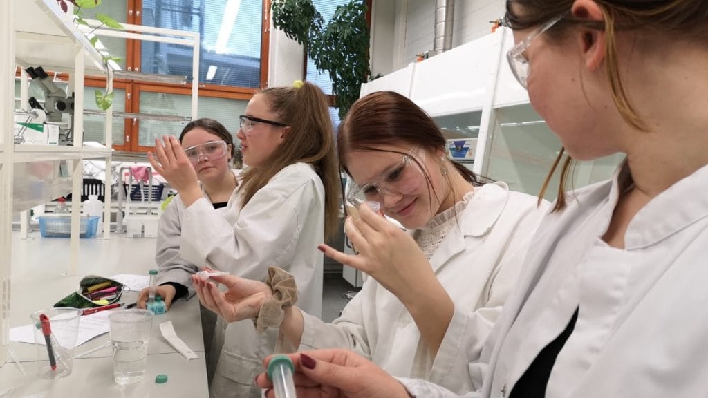 Students extracting DNA in a laboratory.