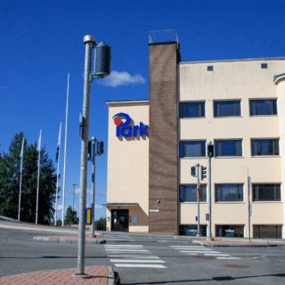 Etualalla liikennevalot ja suojatie. Taustalla rakennus, jonka seinässä lukee iPark.